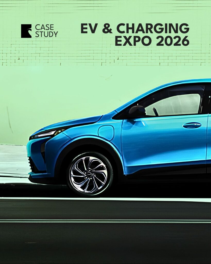 Blue electric vehicle drives past a pale green wall with a banner that reads 'EV & CHARGING EXPO 2026' and shows a Case Study logo.